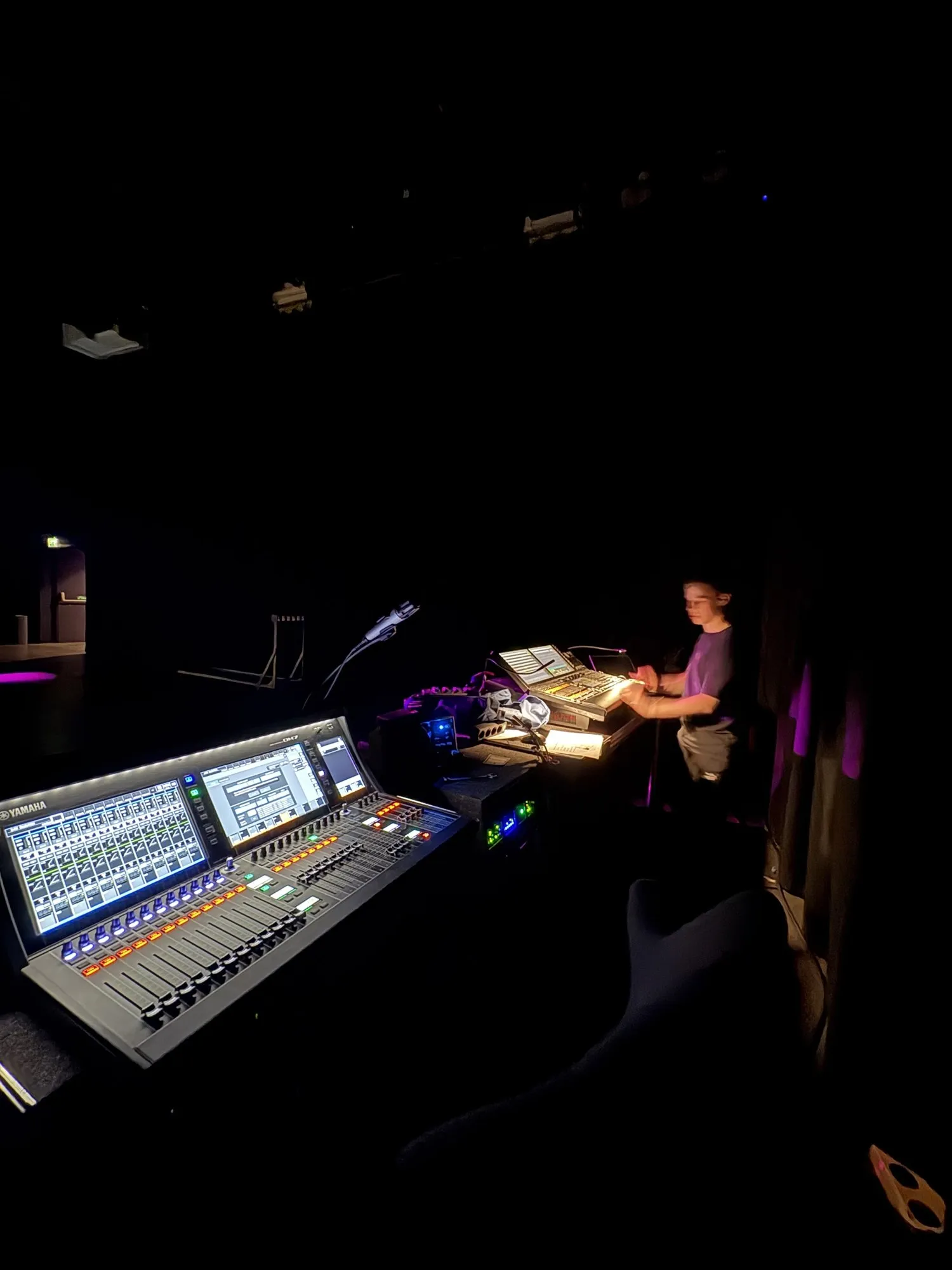 A mixing console in the dark during the show